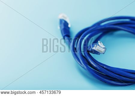 Blue Ethernet Cable Cord Patch Cord On A Blue Background With Free Space
