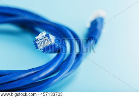 Two Ethernet Cable Connectors Patch Cord Cord Close-up Isolated On A Blue Background With Free Space