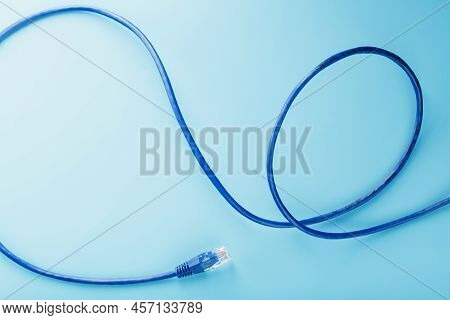 Ethernet Cable Connector Patch Cord Cord Close-up On A Blue Background With Free Space