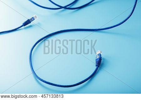 Blue Ethernet Cable Cord Patch Cord On A Blue Background With Free Space