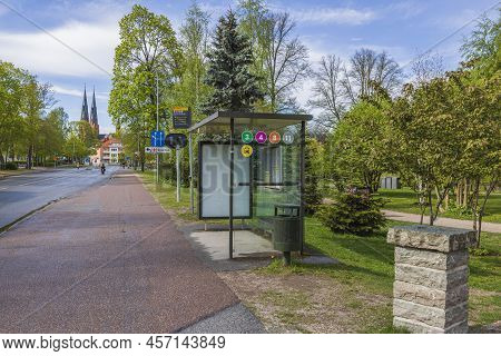 Close Up View Of Buss Stop On Green Trees And Cathedral Church Towers And Blue Sky On Background. Sw