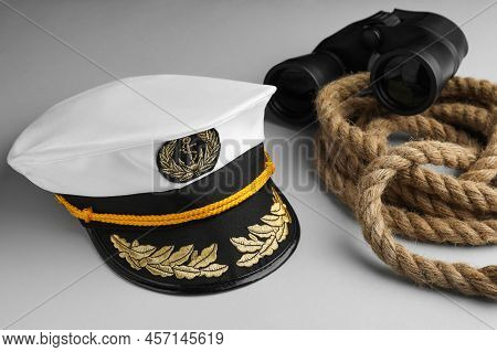Peaked Cap, Rope And Binoculars On Light Grey Background