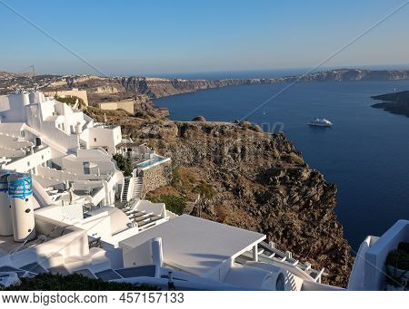 Imerovigli, Santorini, Greece - June 29, 2021: Whitewashed Houses With Terraces And Pools And A Beau