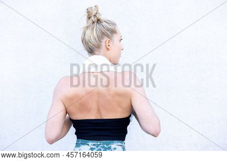 Half Body Rear View Shot Of A Gym Fit Caucasian Sporty Woman Dressed In Sportswear And With Her Hair