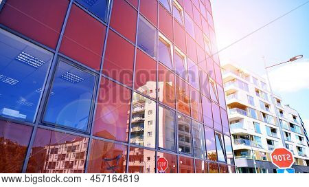 Modern Office Building With Glass Facade On A Clear Sky Background. Transparent Glass Wall Of Office