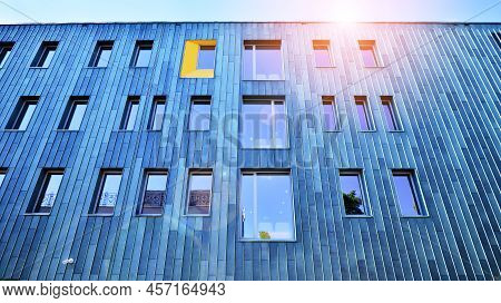 Fragment Of Modern Urban Geometry. Walls  Office Building Made Of Steel And Glass. Bright Sunny Day 