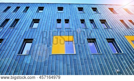 Fragment Of Modern Urban Geometry. Walls  Office Building Made Of Steel And Glass. Bright Sunny Day 