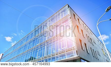 Modern Office Building With Glass Facade On A Clear Sky Background. Transparent Glass Wall Of Office