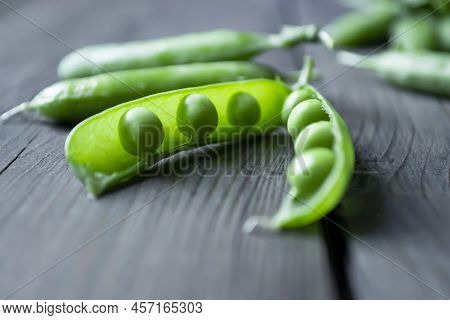 Green Pea Beans In A Pod On A Wooden Table. Beans In A Pod. Green Peas With Open Pod.