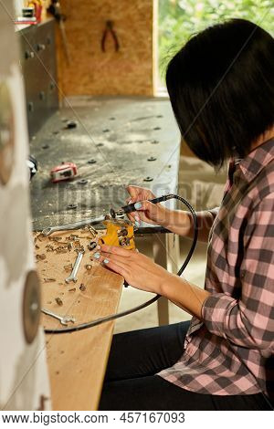 Woman Using Power Working Grinder Machine, Female Hand Grinds A Metal Nuts
