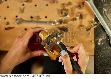 Woman Using Power Working Grinder Machine, Female Hand Grinds A Metal Nuts