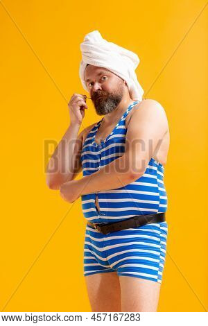 Comic Portrait Of Funny Fat Bearded Man In Vintage Style Striped Swimsuit Having Fun Isoltaed On Yel