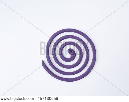 Purple Coiled Mosquito Repellent On A White Background.