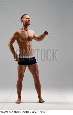 Young Male Athlete Posing. Handsome Athletic Male Power Guy. Fitness Muscular Person. Young Athlete 