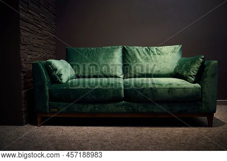 Comfortable Upholstered Velour Green Sofa Displayed For Sale In The Furniture Store Showroom. Exhibi