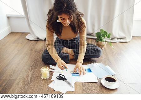 Young Brunette African American Woman Creating Her Feng Shui Wish Map Using Scissors. Dreams And Wis