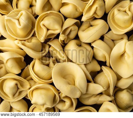 Closeup Of Uncooked Italian Pasta Cappelletti Or Tortellini.