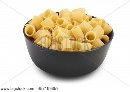 Raw Italian Pasta In Ceramic Bowl Isolated On White Background . Mezze Maniche Rigate Bronze Die
