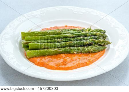 Fried Asparagus With Romesco Sauce On White Plate