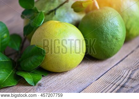 Pomelo Fruit On Wooden Background, Fresh Green Pomelo And Leaf Frome Pomelo Tree , Pummelo , Grapefr