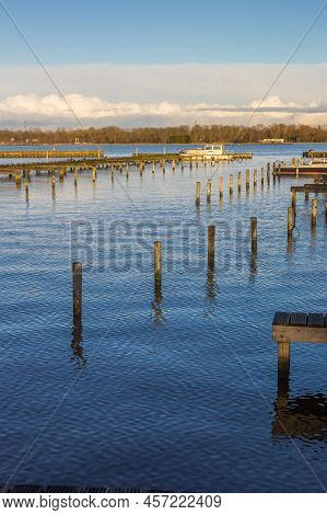 Wooden Poles At The Harbor Of The Schildmeer Lake In Groningen, Netherlands