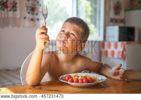 Blond Child In Domestic Kitchen Eat Healthy Food, Organic Vegan Fritatta  With Vegetables.