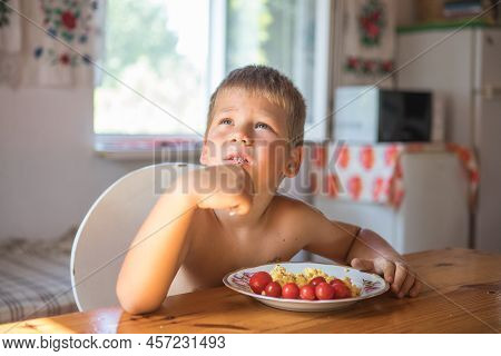 Blond Child In Domestic Kitchen Eat Healthy Food, Organic Vegan Fritatta  With Vegetables.