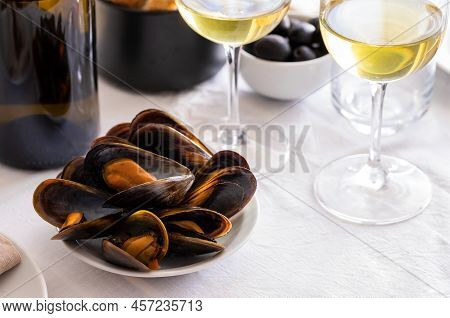 Steamed Mussels With Glass Of Wine On The Table In Restaurant. Typical Mediterranean's Dish