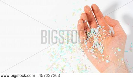 Shot Of Microplastics Lay On People Hand. Concept Of Water Pollution And Global Warming. The Idea Of