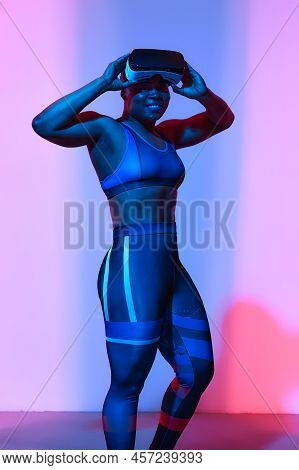 Modern African Black Woman With Short Hiar In Sport Top And Leggings Wearing Glasses Of Virtual Real