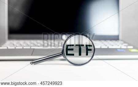 Etf Analysis Concept. Word Through Magnifying Glass. High Quality Photo