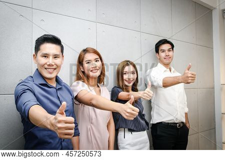 A Group Of Young Business Men And Women Of Asia Thumbs Up. Together To Develop Business And Organiza