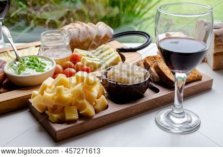 Delicious Charcuterie Board With Snacks Cheese, Toast, Ham, Blue Cheese, Almonds, Caramelized Onions