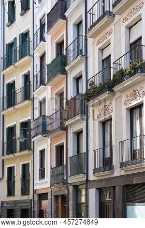 Facades Of Several Restored Old Houses On A Narrow Street Full Of Small Balconies, Historic Downtown