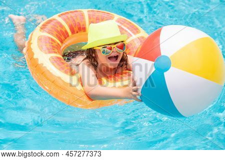 Kids Swimming And Playing In A Pool. Child Playing In Swim Pool. Summer Fashion Kids Portrait. Vacat