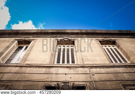 Facade Of A Typical Old French Residential Building In Bordeaux, France, Made Of Freestone, Hosting 