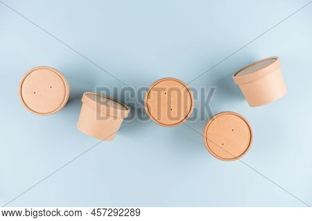 Eco Kraft Paper Food Containers For Soup To Go Or Ice Cream, Cup With Paper Cap Over Light Blue Back