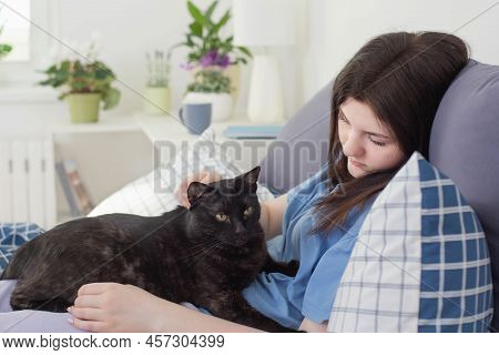 Happy Teen Girl With Black Cat In White Bedroom
