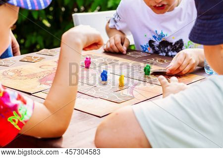 Close-up Game Night With Friends. Hands Control Multi Colored Figures, Movement And Active Argument 