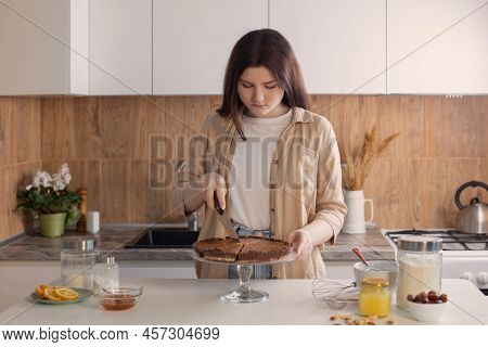 Teen Girl Cooking Nuts Pie In Kitchen