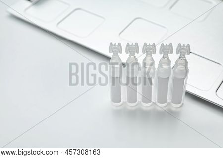 Single Dose Ampoules Of Sterile Isotonic Sea Water Solution On White Background. Space For Text