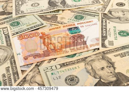 Russian 5000 Rubles And 100 Dollars Close Up, Concept Of Finance Is Laid Out As A Background. Ruble 
