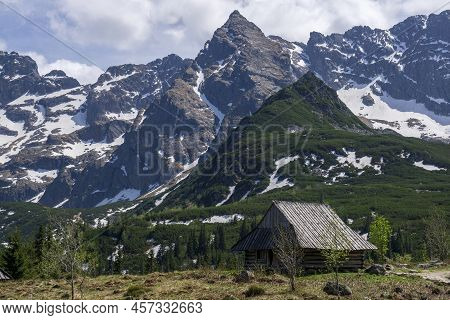 Gasienicowa Valley. Tatra Mountains. An Old Hut In The Background Of The Koscielec Peak.