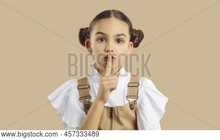 Beautiful Little Girl Puts Her Finger On Her Lips And Asks You To Keep Her Secret