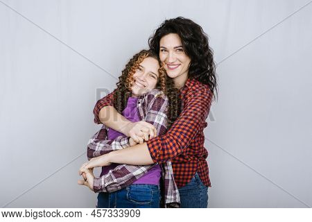 Portrait Of Happy Mom And Teeneger Daughter Spend Time Together. Teenage Girl Hugging Her Mother
