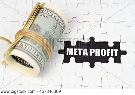 Business Concept. Dollars Lie On White Puzzles, On A Black Surface There Is An Inscription - Meta Pr