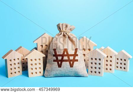 South Korean Won Money Bag Among Town Houses Figurines. Rich City. Rental Business. Realtor Services