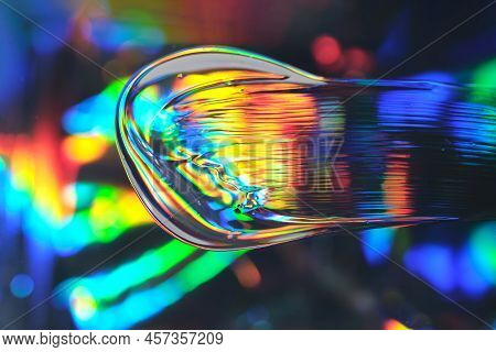 Drop Of Cosmetic Transparent Gel On A Halographic Background. The Texture Of The Serum, Heir Gel Or 