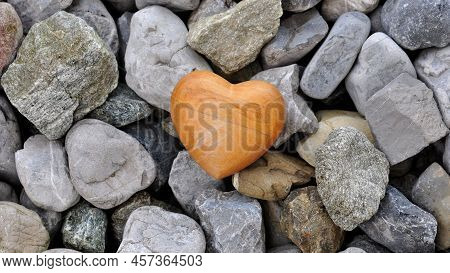 Small Marble Stones And One Heart Shaped Stone. Different Shapes Of Rock Material Stones With Yellow