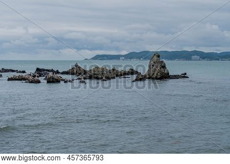 Rock Formations In Ocean Water Off Shore Near Ulsan, South Korea. Aka Gunham Rock.